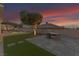 A tranquil backyard view with a modern fire pit, lush greenery, and a glimpse of the refreshing swimming pool at 1124 Whistle Ct, Henderson, NV 89011