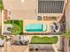 Aerial view of a backyard featuring a sparkling pool, lush greenery, and patio seating area at 1124 Whistle Ct, Henderson, NV 89011