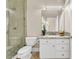 Well-lit bathroom with a glass-enclosed shower, granite countertop, and white cabinetry at 1124 Whistle Ct, Henderson, NV 89011