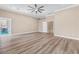 Spacious bedroom featuring modern ceiling fan, neutral color palette and wood-look floors at 1124 Whistle Ct, Henderson, NV 89011