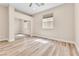 Bright and spacious bedroom with wood laminate flooring, neutral walls, and a mirrored closet at 1124 Whistle Ct, Henderson, NV 89011