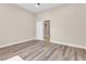 A serene bedroom featuring wood laminate floors, neutral paint, and ample natural light coming through a window at 1124 Whistle Ct, Henderson, NV 89011