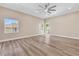 Bright bedroom featuring a large window, neutral color palette and modern wood-look floors at 1124 Whistle Ct, Henderson, NV 89011