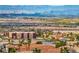 A scenic view overlooking a community, with the city skyline and mountains in the distance at 1124 Whistle Ct, Henderson, NV 89011