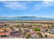 A scenic view overlooking a sprawling community, with the city skyline and majestic mountains as a backdrop at 1124 Whistle Ct, Henderson, NV 89011