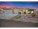 Charming home featuring a three-car garage, stone accents, and a beautifully landscaped front yard at 1124 Whistle Ct, Henderson, NV 89011