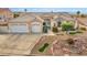 Home with a three-car garage, well-manicured lawn, and charming desert landscaping for curb appeal at 1124 Whistle Ct, Henderson, NV 89011