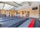 Spacious garage featuring a clean, epoxy-coated floor, ample storage cabinets, and a mounted television at 1124 Whistle Ct, Henderson, NV 89011