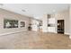 Spacious living room with neutral tones, tiled flooring, large windows and a wine cooler at 1124 Whistle Ct, Henderson, NV 89011