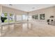 Bright living room with travertine tile, large windows and built-in storage cabinets at 1124 Whistle Ct, Henderson, NV 89011