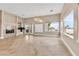 Bright living room with travertine tile floors, fireplace and large windows at 1124 Whistle Ct, Henderson, NV 89011