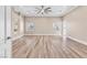 Expansive primary bedroom featuring wood flooring, ceiling fan and convenient access to the ensuite bathroom at 1124 Whistle Ct, Henderson, NV 89011