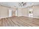 Spacious primary bedroom showcasing hardwood floors, ceiling fan and ensuite bathroom access at 1124 Whistle Ct, Henderson, NV 89011