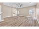 Large primary bedroom showcasing hardwood floors, crown molding, a ceiling fan, and backyard views at 1124 Whistle Ct, Henderson, NV 89011