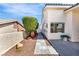 Property side yard features a concrete walkway and rock landscaping with plants at 1124 Whistle Ct, Henderson, NV 89011