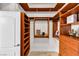 Bright, well-organized walk-in closet featuring custom wood shelving, drawers, and ample storage space at 1124 Whistle Ct, Henderson, NV 89011