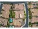 An aerial view of homes featuring red tiled roofs, green lawns, and mature landscaping at 2805 Proust Ct, Henderson, NV 89044