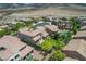 Aerial view of the property showcasing a backyard, pool, lush landscaping, and tiled roof at 2805 Proust Ct, Henderson, NV 89044