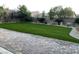 Paver patio leads to low-maintenance artificial turf backyard with mature landscaping at 2805 Proust Ct, Henderson, NV 89044