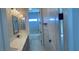 Bright bathroom features marble tiling, white vanity with black hardware, shower-tub, and a window at 2805 Proust Ct, Henderson, NV 89044