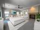Spacious bedroom featuring a fireplace, hardwood floors, ceiling fan, and sitting area with two beds at 2805 Proust Ct, Henderson, NV 89044
