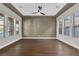 Bonus room featuring wood floors, ceiling fans, and several windows for natural light at 2805 Proust Ct, Henderson, NV 89044