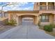 Covered carport area between house and garage, featuring stone accents and a tile roof at 2805 Proust Ct, Henderson, NV 89044