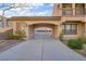 Long driveway leading to a three car garage, with covered porte-cochere at 2805 Proust Ct, Henderson, NV 89044