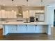 Elegant kitchen boasts white cabinetry, quartz countertops, and stainless steel appliances at 2805 Proust Ct, Henderson, NV 89044