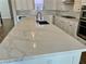 Spacious kitchen featuring an expansive quartz island and modern fixtures at 2805 Proust Ct, Henderson, NV 89044