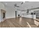 Open floor plan featuring fireplace, wood floors, ceiling fans, and a large kitchen with stainless appliances at 2805 Proust Ct, Henderson, NV 89044