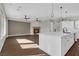 Open-concept living space with fireplace, hardwood floors, and access to a modern kitchen at 2805 Proust Ct, Henderson, NV 89044