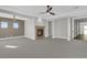 Spacious living room featuring a cozy fireplace, neutral decor, and ceiling fan at 2805 Proust Ct, Henderson, NV 89044