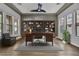 Home office with hardwood floors, built-in bookshelves, large desk, natural light, and a ceiling fan at 2805 Proust Ct, Henderson, NV 89044