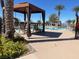 Community pool area featuring cabanas, lounge chairs, and palm trees at 2805 Proust Ct, Henderson, NV 89044