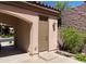 Side entrance with a brown door and stone accents, framed by well-maintained landscaping and greenery at 2805 Proust Ct, Henderson, NV 89044