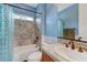 Cozy bathroom featuring a tub with shower and a charming accent wall with a large mirror at 2824 Sisteron Ct, Henderson, NV 89044
