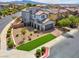 Beautiful home with a landscaped front yard, mature trees, and a paved driveway at 301 Resolute Ave, Henderson, NV 89011