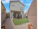 Private backyard featuring a covered patio, artificial grass, and gravel for low maintenance enjoyment at 301 Resolute Ave, Henderson, NV 89011