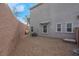 Low-maintenance backyard features gravel landscaping, privacy wall, and compact AC unit at 301 Resolute Ave, Henderson, NV 89011