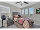 Comfortable bedroom featuring a ceiling fan, multiple windows, and stylish decor for a relaxing ambiance at 301 Resolute Ave, Henderson, NV 89011