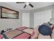 Cozy bedroom with ceiling fan, white closet doors, and a large picture that enhances the aesthetic appeal at 301 Resolute Ave, Henderson, NV 89011