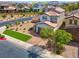 Well-maintained home with desert landscaping, manicured lawn, and neutral color palette at 301 Resolute Ave, Henderson, NV 89011