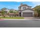 Two-story home featuring neutral paint, stone accents, and brick paved driveway at 301 Resolute Ave, Henderson, NV 89011