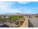 Rooftop view showcasing the neighborhood's houses, streets, and mountain range in the distance at 301 Resolute Ave, Henderson, NV 89011