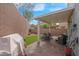 Relaxing covered patio offers ample seating space, with brick pavers and artificial turf at 301 Resolute Ave, Henderson, NV 89011