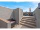 Relaxing rooftop patio with outdoor seating, stairs, and textured stucco wall perfect for unwinding at 301 Resolute Ave, Henderson, NV 89011