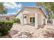 This charming backyard features a covered patio, rock landscaping, and tasteful desert shrubbery at 3029 Paseo Hills Way, Henderson, NV 89052