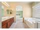 Spacious bathroom with dual vanity, soaking tub, and natural light, all complemented by neutral tones at 3029 Paseo Hills Way, Henderson, NV 89052