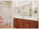 Well-lit bathroom with a large vanity, spacious mirror, and a shower-tub combo at 3029 Paseo Hills Way, Henderson, NV 89052